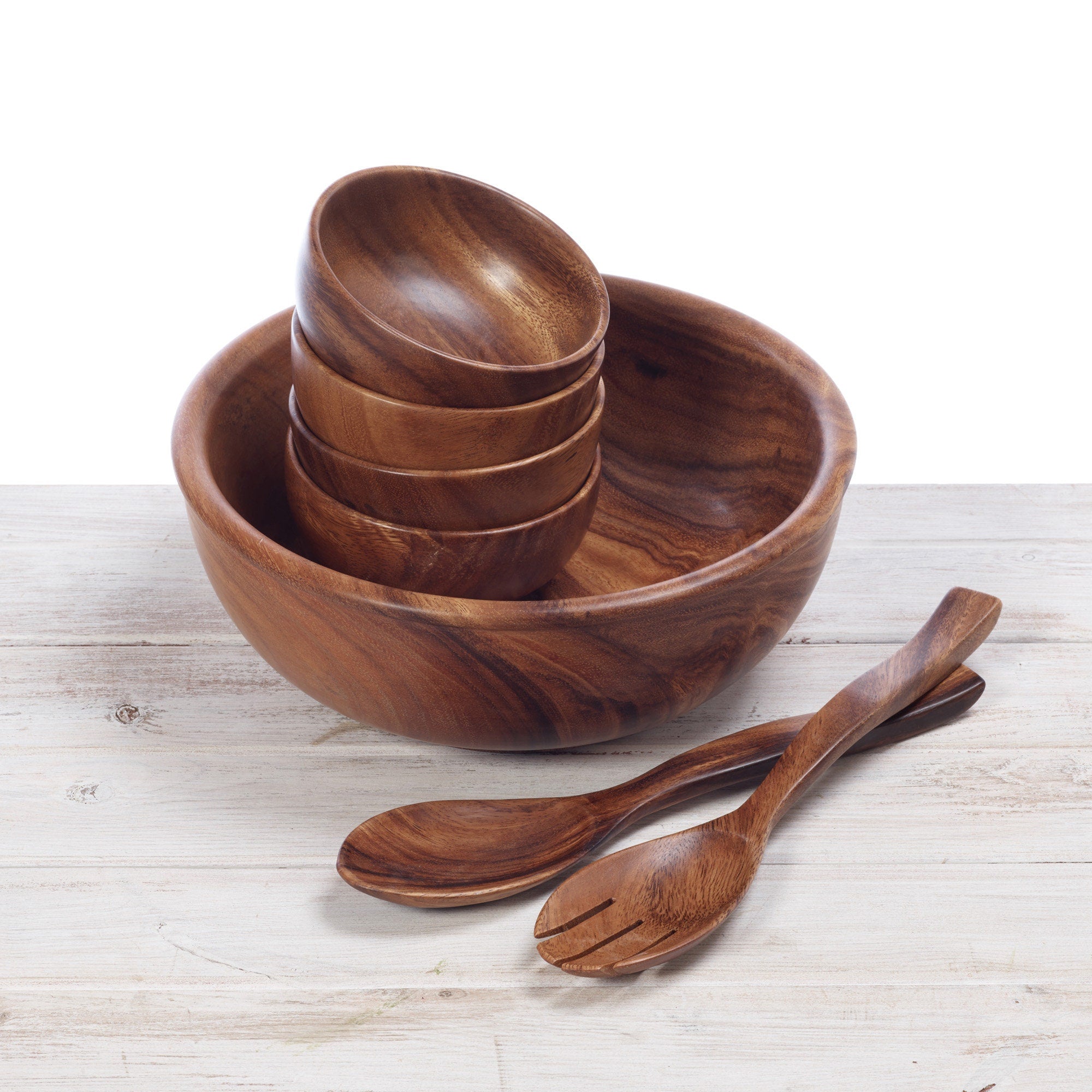 stacked wooden tableware and salad bowls